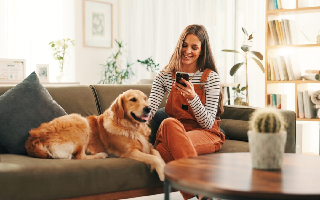 women sitting on couch in apartment petting her dog